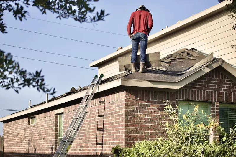 Professional roofer working on a residential roof in Hunts Corner